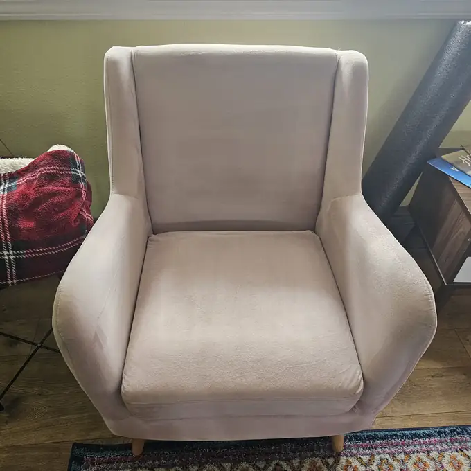 Same armchair after steam cleaning — cushion clean and even