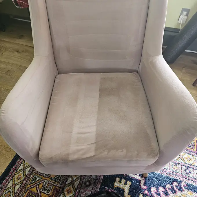 Upholstered armchair before cleaning — soiled seat cushion