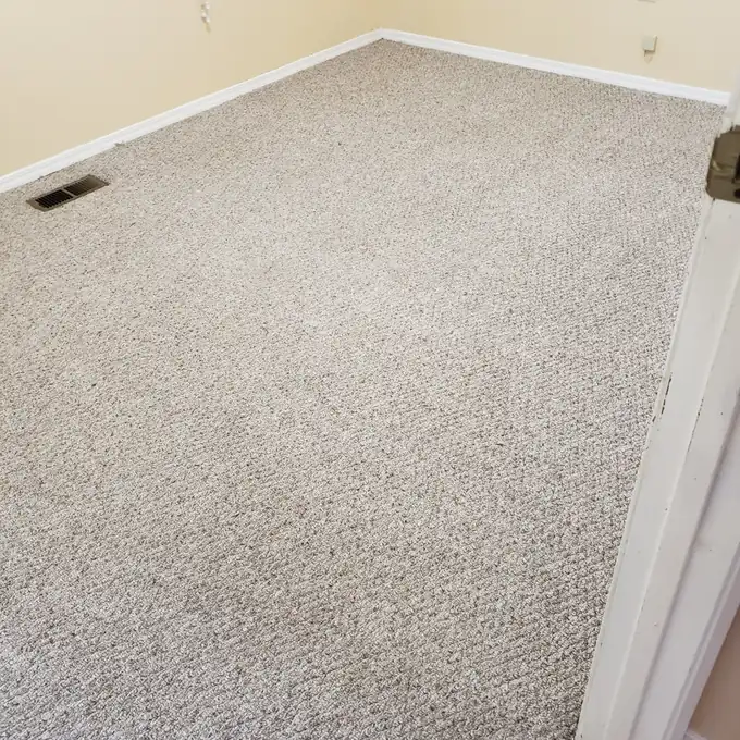 Same beige carpet after steam cleaning — clean and even wall to wall