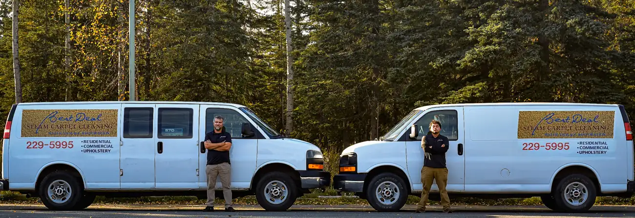 Esteban and Angel standing in front of two Best Deal Steam Carpet Cleaning vans in Anchorage